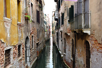Fototapeta na wymiar Narrow Water Canal Between Residential Houses in a Quiet Area of Venice, Italy