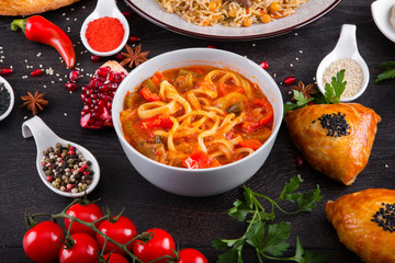 The concept of Eastern asian festive cuisine. Assorted Uzbek food set, pilaf, samsa, lagman, manta, shurpa restaurant concept, Uzbek food. Homemade Eastern arabic new year and Christmas dish from lamb