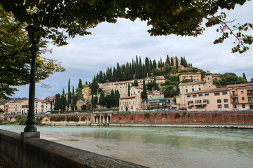 The cityscape of the ancient town of Verona in Italy. You can see the river Adige and the houses by the riverside. 