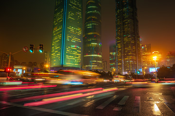 Fototapeta na wymiar Light trails on the modern building background in Shanghai, China.
