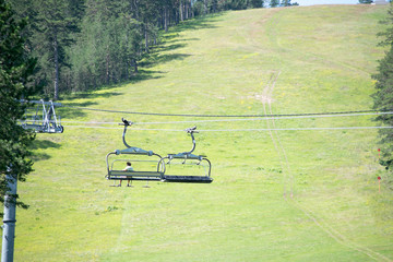 summer mountain landscape with ski lift in a ski base