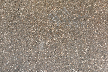 Asphalt with stone chips close-up. Empty background for layouts and sites.