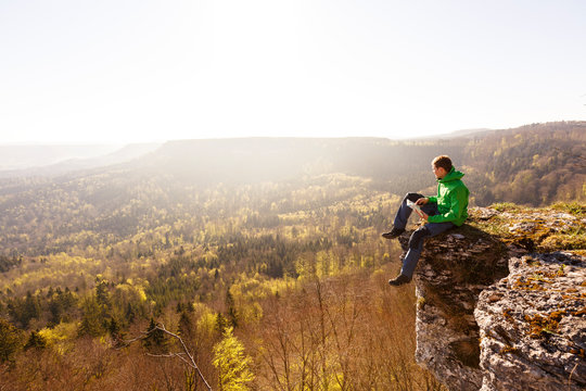 Albstatt-Onstmettingen, Baden-W&cedil;rttemberg, Germany: A male hiker on the "Hangender Stein" cliff along the "Traufgang Zollernburg-Panorama" trail.