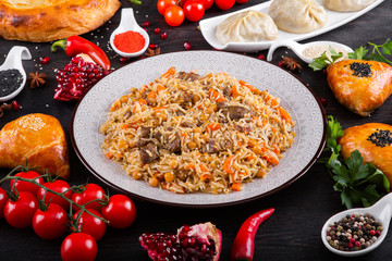 The concept of Eastern asian festive cuisine. Assorted Uzbek food set, pilaf, samsa, lagman, manta, shurpa restaurant concept, Uzbek food. Homemade Eastern arabic new year and Christmas dish from lamb
