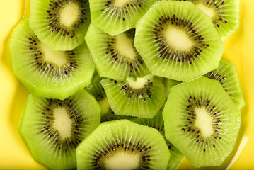 slices of kiwi on yellow plate