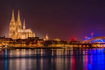 Fototapeta na wymiar Evening scene over Cologne Koln city with Kolner Dom Cathedral behind the Hohenzollern bridge