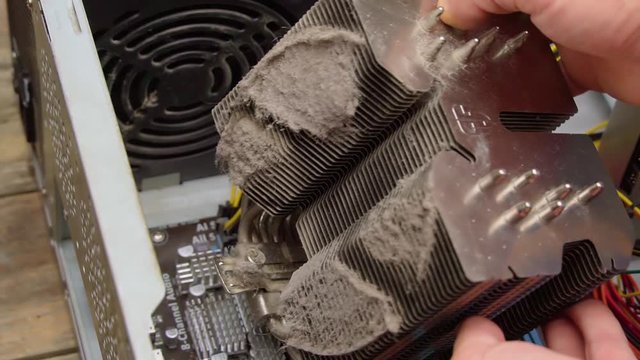 the wizard dismantles the computer. Heap of dust on a processor heatsink / heatsink for a computer processor close-up.