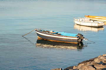Fishing boats floating on the Mediterranean sea shore. Italy.
