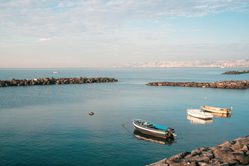 Obraz premium Fishing boats floating on the Mediterranean sea shore. Italy.