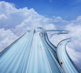 Concept of the highway intersection in clouds sky