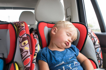 boy sleepping in car seat