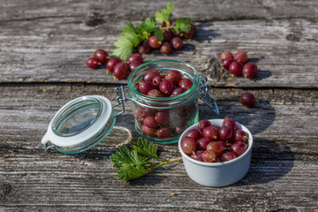 Gooseberries fresh berries in a white plate and wooden background