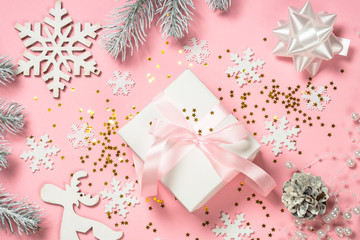 Christmas flat lay background with christmas present box on pink.