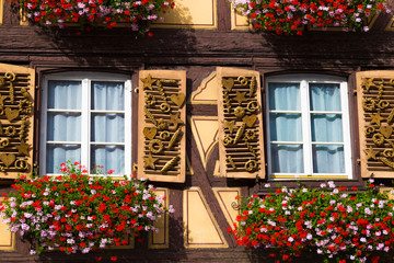 Fototapeta na wymiar Beautiful facade of an ancient half-timbered house with many windows