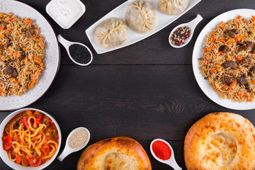 The concept of Eastern asian festive cuisine. Assorted Uzbek food set, pilaf, samsa, lagman, manta, shurpa restaurant concept, Uzbek food. Homemade Eastern arabic new year and Christmas dish from lamb