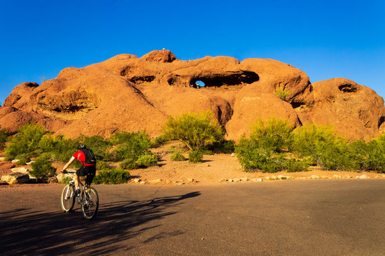 Beautiful, bright afternoon at Papago park, Phoenix, Arizona. Biker on the road enjoying.