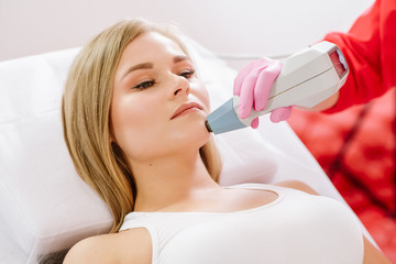 Woman taking treatment with radio wave lifting in the SPA center