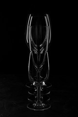 Empty glass glass for wine and liquor on a dark background under the concrete.