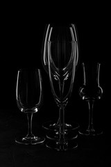 Empty glass glass for wine and liquor on a dark background under the concrete.