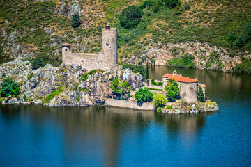 Fototapeta na wymiar Ruines of the old castle and medieval chapel in the Grangent island. Gorges de la Loire, Saint Etienne region, France.