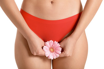 Young woman with flower on white background. Gynecology concept