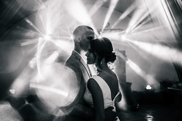 newlyweds in a beautiful light.black white bride and groom dance photo