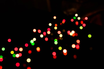 unfocused blurry glowing red, green and yellow lights for wallpaper and design isolated on black