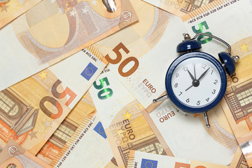 alarm clock on banknotes
