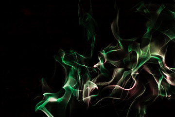 Green fire forms abstraction in black background