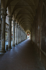 Portico passage with roman style columns in Bologna, Italy