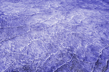 Pattern of sea waves toned in shades of purple