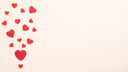 Valentines Day card. Creative layout with red hearts on pastel beige background. Minimal flat lay style composition, top view, copy space. Valentines Day, love, romance concept.