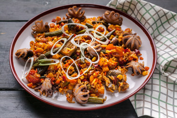 Close-up Traditional spanish paella with octopuses. Mediterranean food. Ketogenic Diet Recipes