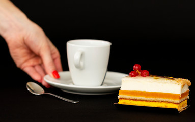 multilayer cake with airy white cream and red currant, mouth watering dessert, white cup with a...