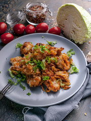 Close-up Stewed cod with brussels sprouts in tomato sauce. Healthy seafood. Ketogenic diet