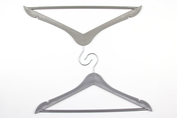 gray clothes hanger on a white background. The choice of style of fashionable clothes