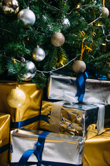 Christmas tree with gifts. Gold and silver