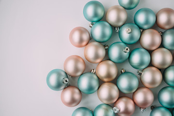 Christmas balls of mint and peach color on a light background.