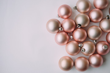 Christmas balls peach color on a light background.