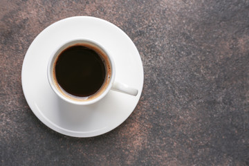 Cup of hot coffee on grey background