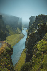 Naklejka na ściany i meble Fjaðrárgljúfur canyon in Iceland in the fog.