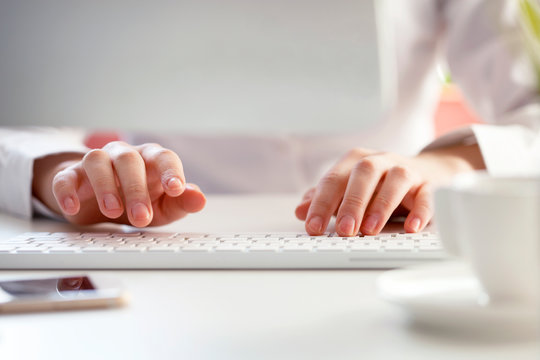 woman hands typing on laptop