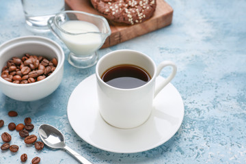 Cup of hot coffee on color background