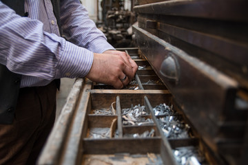 Close up of a hands with old letterpress blocks