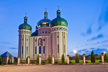 Church in the light of evening lanterns. Holy Protection Church in the city Dubno, Ukraine