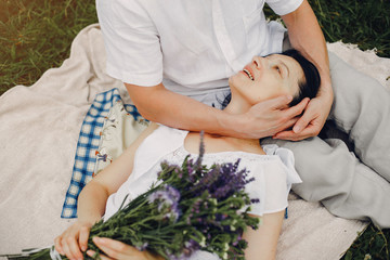 Obraz premium Adult couple in a summer field. Handsome senior in a white shirt. Woman in a white blouse