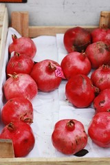 Fresh red pomegranates on the market close up