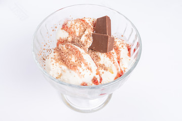 Ice cream balls in a vase. With a piece of chocolate.