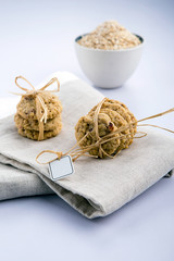 oats drop cookies with a white bowl filled with oats