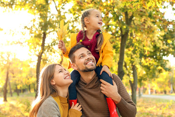 Happy family in autumn park